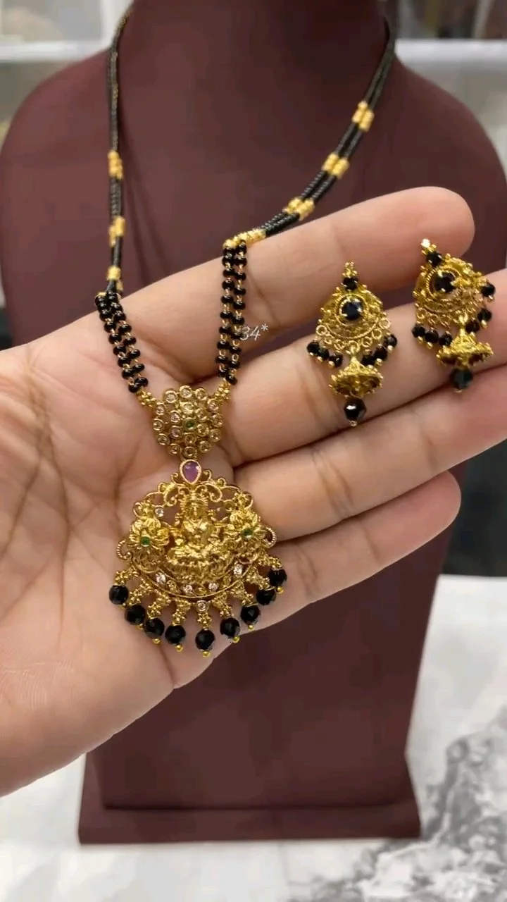 Gold Plated Black Beaded Mangalsutra with Lakshmi Pendant and Earrings thumbnail 1
